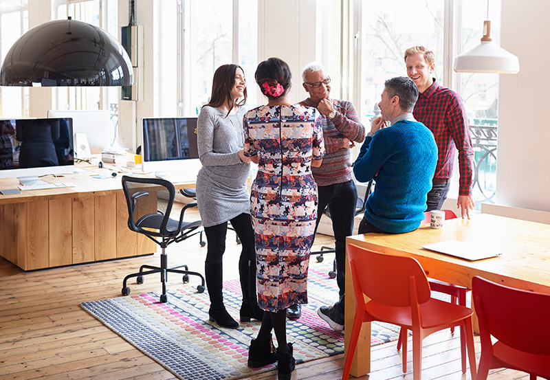 Co-workers in an informal meeting in modern office