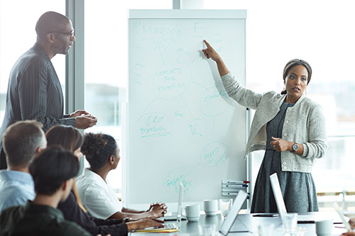 People chatting and laughing in a meeting.